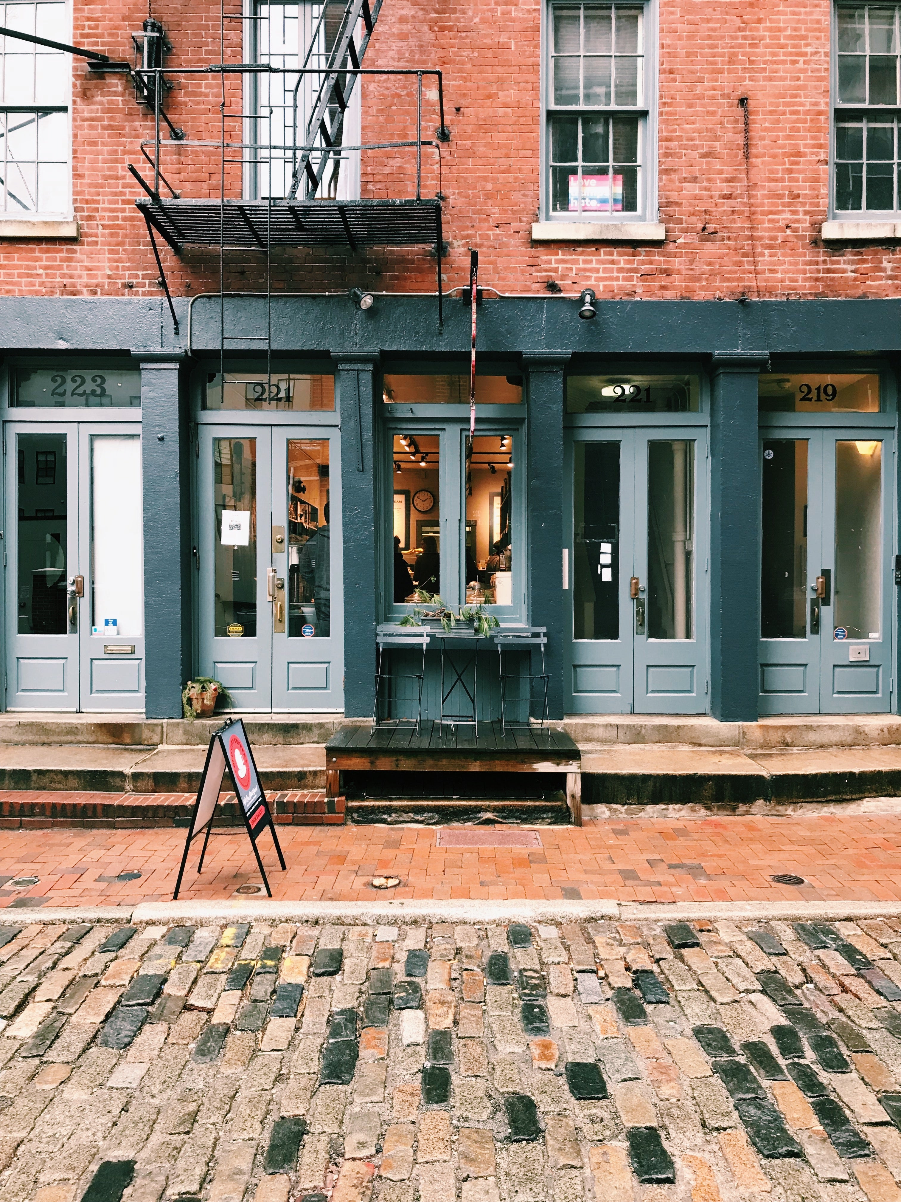 Old City Coffee cafe on Church St on a cloudy autumn day with a table and chair outside